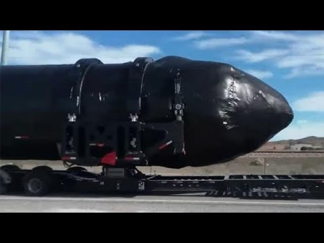 MASSIVE black clad cigar-shaped object filmed near Area 51 on truck
