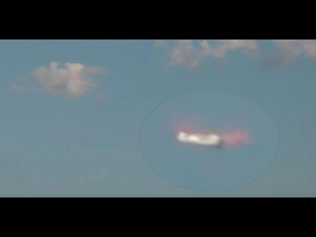UFO stops mid air and radiates pink glow around the fuselage recorded over Poland