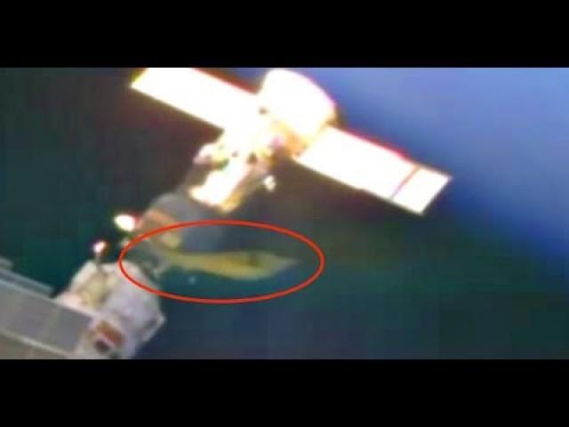 NASA Conspiracy: The case of the Long Yellow UFO Docked At Space Station On Live Camera