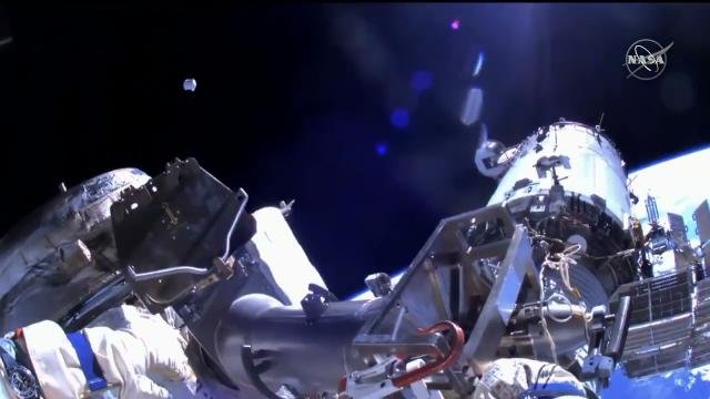 Spacewalkers jettison container outside space station - See it float away!