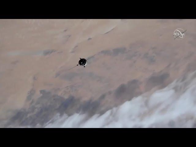 Soyuz with film crew flies around space station in these amazing views