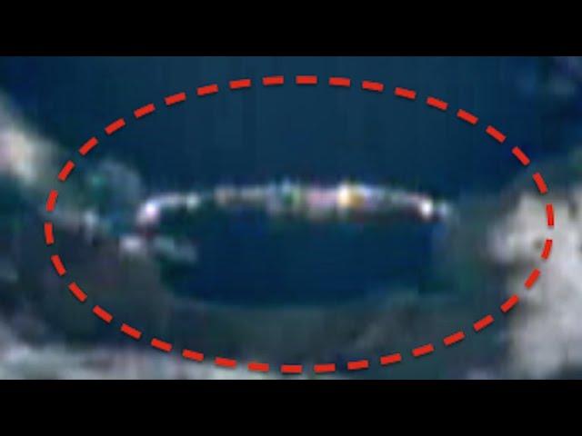 Massive Cigar Shaped UFO Hiding In Clouds Below International Space Station