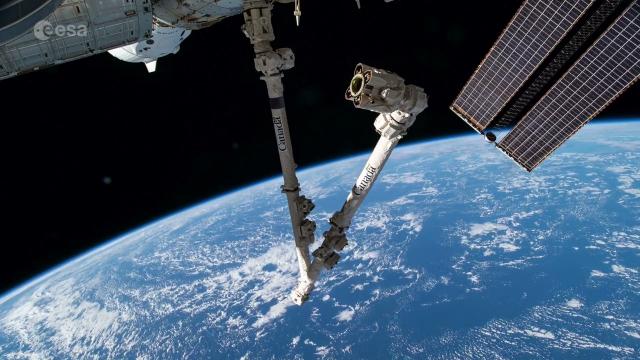 See the space station's robotic arm 'dance' in spectacular over Earth views