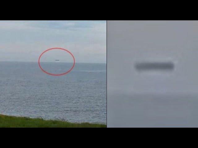 Huge cylinder UFO hovering above Sea in Wales