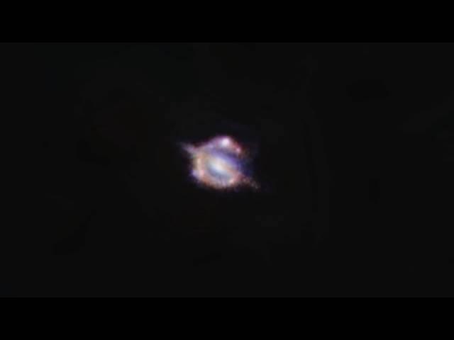 Gravitational Lens Reveals Distant Universe Galaxy Merger | Video