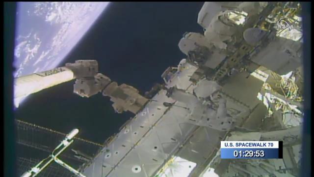 Spacewalker moved by robotic arm in amazing space view