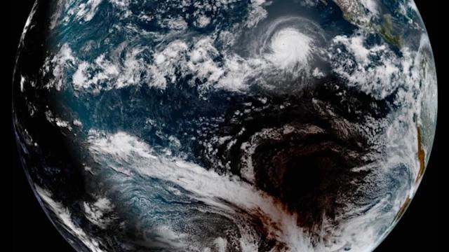Solar Eclipse 2019: Moon's Shadow and Hurricane Seen From Space