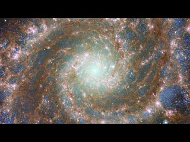 Pan of Combined optical/mid-infrared image of M74 (Hubble and Webb)