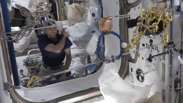 ISS crew plays 'Space Dart' game with ping pong ball and hoops