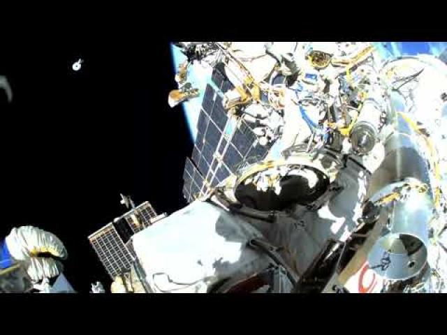 Watch a Russian spacewalker jettison a cable reel cover away from space station