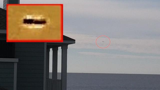Witness filmed this stationary cigar shaped ufo on the coast of Gulf of Mexico