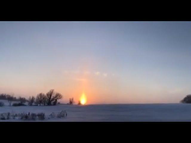 This is just a natural sky phenomenon? Sun pillar with triangular clouds above the pillar?