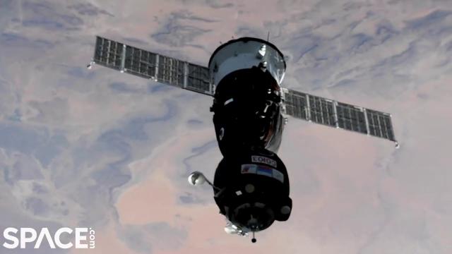 Crewed Soyuz spacecraft docks with space station in time-lapse video